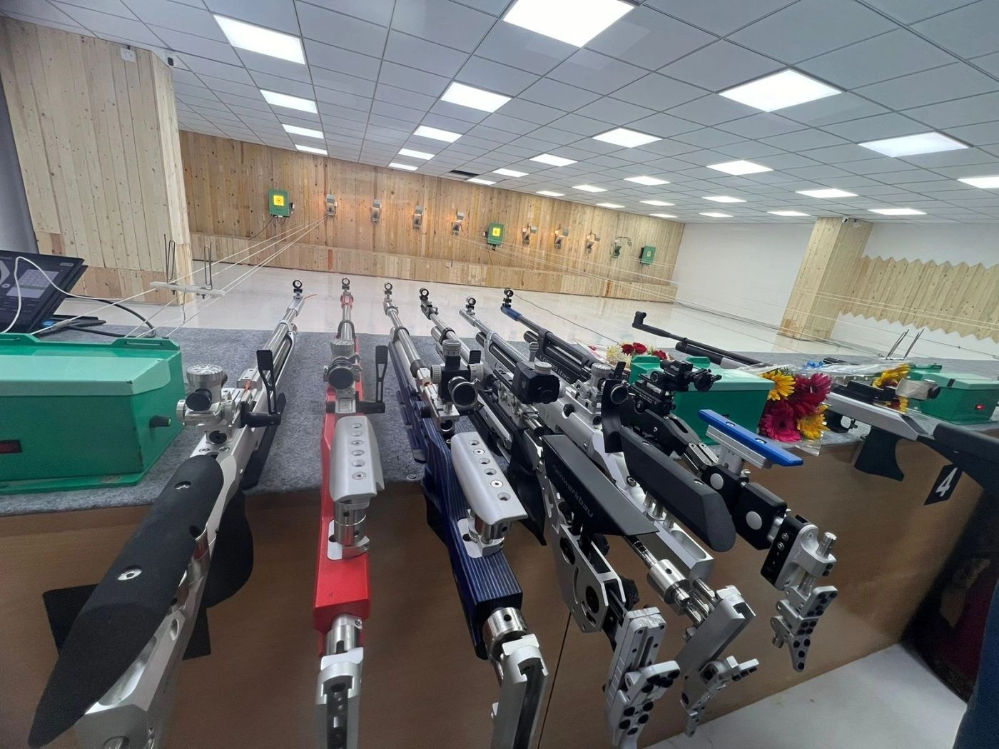 A rack of match air rifles at the firing point of the club's wood-panelled range