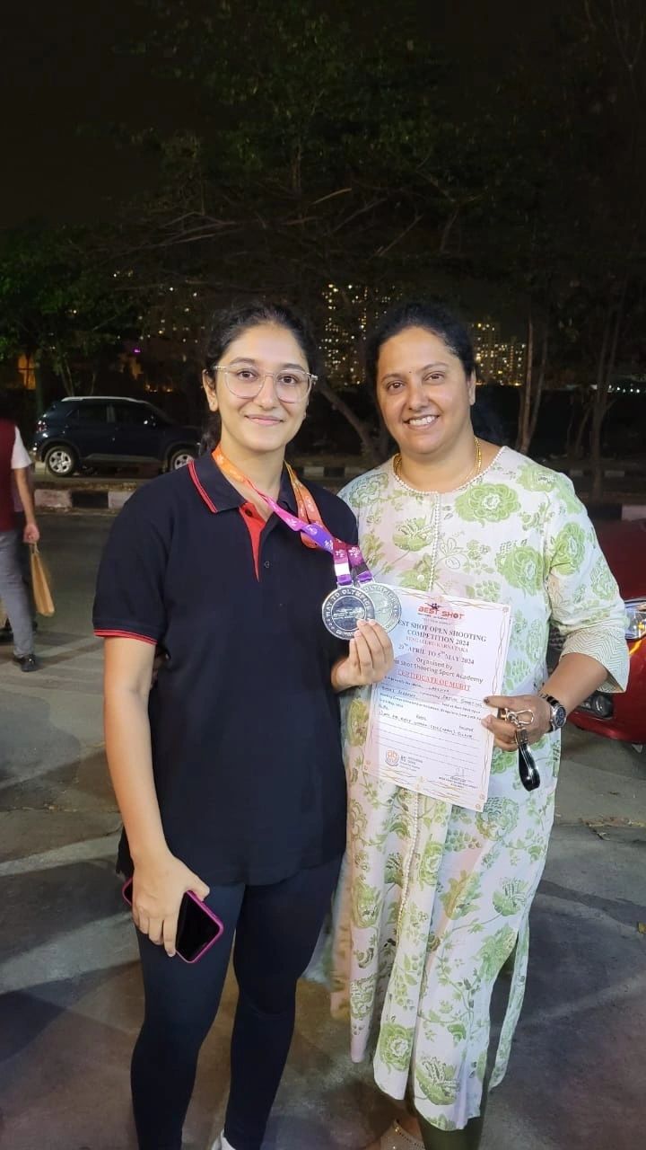 A student with her medal and certificate after a competition